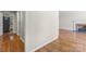 Hallway showcasing hardwood floors and access to the kitchen and living room at 8007 Caldwell Rd, Harrisburg, NC 28075