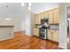This kitchen features stainless steel appliances, granite countertops, and cream colored cabinets at 8007 Caldwell Rd, Harrisburg, NC 28075