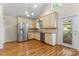Bright kitchen featuring stainless steel appliances, granite countertops, and hardwood flooring at 8007 Caldwell Rd, Harrisburg, NC 28075