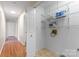 Convenient laundry room with shelving units and hardwood floors at 8007 Caldwell Rd, Harrisburg, NC 28075