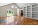 The living room has hardwood floors, lots of natural light, and large built-in bookshelves at 8007 Caldwell Rd, Harrisburg, NC 28075