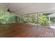 Relaxing screened-in porch with wood flooring and ample space for outdoor seating at 8007 Caldwell Rd, Harrisburg, NC 28075