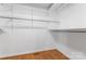 Walk-in closet provides ample storage with shelving units and hardwood flooring at 8007 Caldwell Rd, Harrisburg, NC 28075