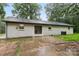 A backyard view of a white painted home with double doors and concrete patio at 848 Ike Lynch Rd, Dallas, NC 28034