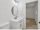 Updated bathroom features a modern vanity with matte black hardware and a round mirror at 848 Ike Lynch Rd, Dallas, NC 28034