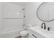 Modern bathroom features a sleek vanity, subway tile shower, and modern round mirror at 848 Ike Lynch Rd, Dallas, NC 28034