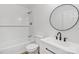 Modern bathroom features a sleek vanity, subway tile shower, and modern round mirror at 848 Ike Lynch Rd, Dallas, NC 28034