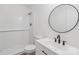 Updated bathroom features white subway tile shower and updated vanity with a round mirror at 848 Ike Lynch Rd, Dallas, NC 28034