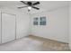 Carpeted bedroom features a closet and a bright window at 848 Ike Lynch Rd, Dallas, NC 28034