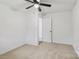Bedroom with carpet and ceiling fan featuring a door to the hallway and a bright window at 848 Ike Lynch Rd, Dallas, NC 28034