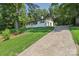 Quaint home with a long driveway lined with lush trees and greenery, ensuring privacy and a serene setting at 848 Ike Lynch Rd, Dallas, NC 28034