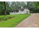 Charming single-story home with a brick facade, surrounded by lush greenery and a private driveway at 848 Ike Lynch Rd, Dallas, NC 28034