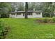 Classic brick home with a well-kept lawn and mature tree creating a serene setting at 848 Ike Lynch Rd, Dallas, NC 28034