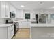 Bright kitchen with stainless steel appliances, white cabinets, and eat-in island at 848 Ike Lynch Rd, Dallas, NC 28034