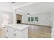 Inviting living area with a cozy brick fireplace, hardwood floors, and an open flow to the kitchen at 848 Ike Lynch Rd, Dallas, NC 28034
