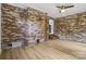 Cozy living room featuring a brick accent wall, hardwood floors, and lots of natural light at 848 Ike Lynch Rd, Dallas, NC 28034