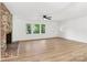 Bright living room features a brick fireplace, lots of windows, new floors, and ceiling fan at 848 Ike Lynch Rd, Dallas, NC 28034