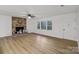 Spacious living room featuring a cozy brick fireplace, bright windows and modern flooring at 848 Ike Lynch Rd, Dallas, NC 28034