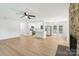 Bright, open-concept space featuring hardwood floors, modern kitchen, brick fireplace, and lots of natural light at 848 Ike Lynch Rd, Dallas, NC 28034