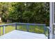 View of the back deck overlooking a large backyard with mature trees and a privacy fence at 9904 Brigstock Ct, Charlotte, NC 28269