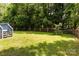 Large, well-maintained backyard featuring a wooden fence and mature trees for privacy at 9904 Brigstock Ct, Charlotte, NC 28269