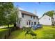 Exterior view of a two-story home with a spacious backyard and wooden deck at 9904 Brigstock Ct, Charlotte, NC 28269