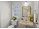 Cozy bathroom with a decorative sink, gold-framed mirror, a toilet, and a window view at 9904 Brigstock Ct, Charlotte, NC 28269