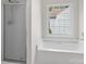 Bathroom featuring a tub and a shower with a glass door, and a window for natural light at 9904 Brigstock Ct, Charlotte, NC 28269