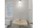 Simple bathroom featuring a toilet, a sink, with a window bringing in natural light at 9904 Brigstock Ct, Charlotte, NC 28269