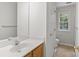 Clean, bright bathroom featuring a single vanity and a window that provides natural light at 9904 Brigstock Ct, Charlotte, NC 28269