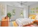 Cozy bedroom with warm decor, featuring two windows, a comfortable bed, and ample natural light at 9904 Brigstock Ct, Charlotte, NC 28269