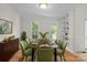Bright dining room featuring a wooden table with seating for eight and a built-in bookshelf at 9904 Brigstock Ct, Charlotte, NC 28269