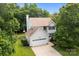 Well-maintained two-story house with an attached garage and a lush green lawn at 9904 Brigstock Ct, Charlotte, NC 28269
