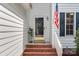 Charming entryway with brick steps, American flag, and a welcoming glass door at 9904 Brigstock Ct, Charlotte, NC 28269