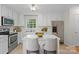 Well-lit kitchen with white cabinetry, stainless steel appliances, island with seating, and a window view at 9904 Brigstock Ct, Charlotte, NC 28269