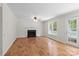 Spacious living room featuring a fireplace, hardwood floors, and bright natural light at 9904 Brigstock Ct, Charlotte, NC 28269