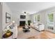 Cozy living room with a fireplace, hardwood floors, and comfortable seating arrangement at 9904 Brigstock Ct, Charlotte, NC 28269