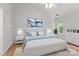 Bright main bedroom with hardwood floors, a ceiling fan, a large bed, and ample natural light at 9904 Brigstock Ct, Charlotte, NC 28269