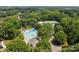 Aerial view of community pool, clubhouse, and surrounding greenery at 9904 Brigstock Ct, Charlotte, NC 28269