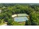 Aerial view of community tennis and sand volleyball courts surrounded by lush trees at 9904 Brigstock Ct, Charlotte, NC 28269