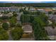 An aerial view shows a home surrounded by lush trees and greenery in a quiet, suburban neighborhood at 110 Whitehall Dr, Mooresville, NC 28117