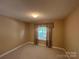 Comfortable bedroom with neutral walls, carpet flooring and natural light from one window at 110 Whitehall Dr, Mooresville, NC 28117