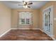 Bright bedroom with hardwood floors, a ceiling fan, and a door that leads to the outside at 110 Whitehall Dr, Mooresville, NC 28117