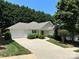Charming single-story home featuring a well-manicured lawn and an attached garage at 110 Whitehall Dr, Mooresville, NC 28117