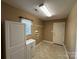 Functional laundry room with cabinets, shelving, and a utility sink at 110 Whitehall Dr, Mooresville, NC 28117