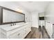 Bathroom with double sinks, marble counters, a large mirror, and wood flooring at 1107 Fairfield Dr, Gastonia, NC 28054