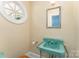 Unique bathroom featuring a turquoise sink, oval window, and decorative mirror at 1107 Fairfield Dr, Gastonia, NC 28054