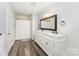 Bathroom with double sinks, marble counters, large mirror, and walk-in shower at 1107 Fairfield Dr, Gastonia, NC 28054