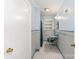 Small hall bathroom featuring tiled floor, vintage sink, and built-in shelves at 1107 Fairfield Dr, Gastonia, NC 28054