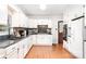 Updated kitchen boasts white cabinets, stone countertops, brick backsplash, and stainless steel appliances at 1107 Fairfield Dr, Gastonia, NC 28054